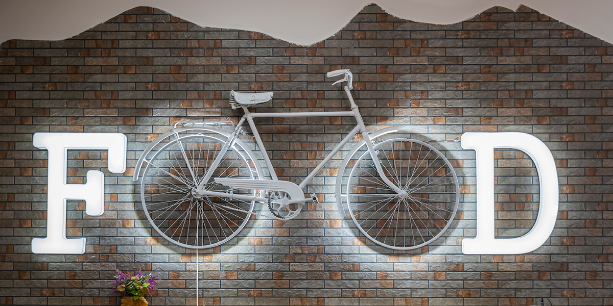 A white bicycle on a brick wall