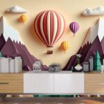 A paper cut out of a mountain with hot air balloons