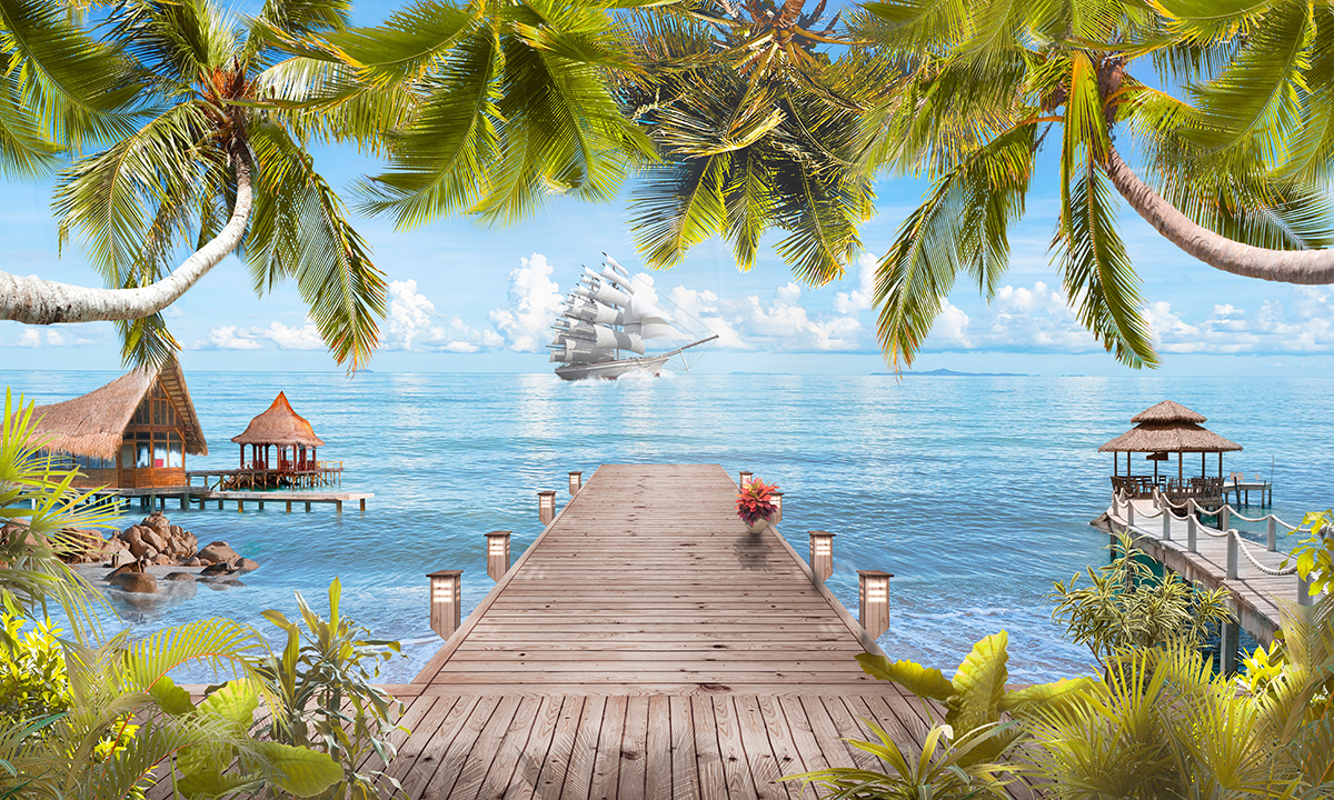 A wooden dock with palm trees and a boat in the water