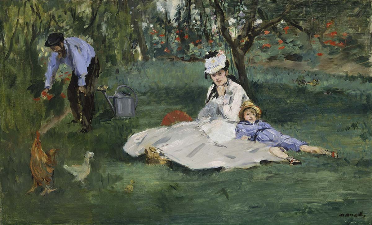 A woman and child sitting on grass