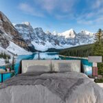 A blue lake surrounded by snow covered mountains