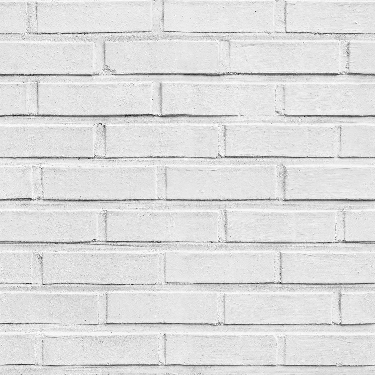 A white brick wall with a few bricks