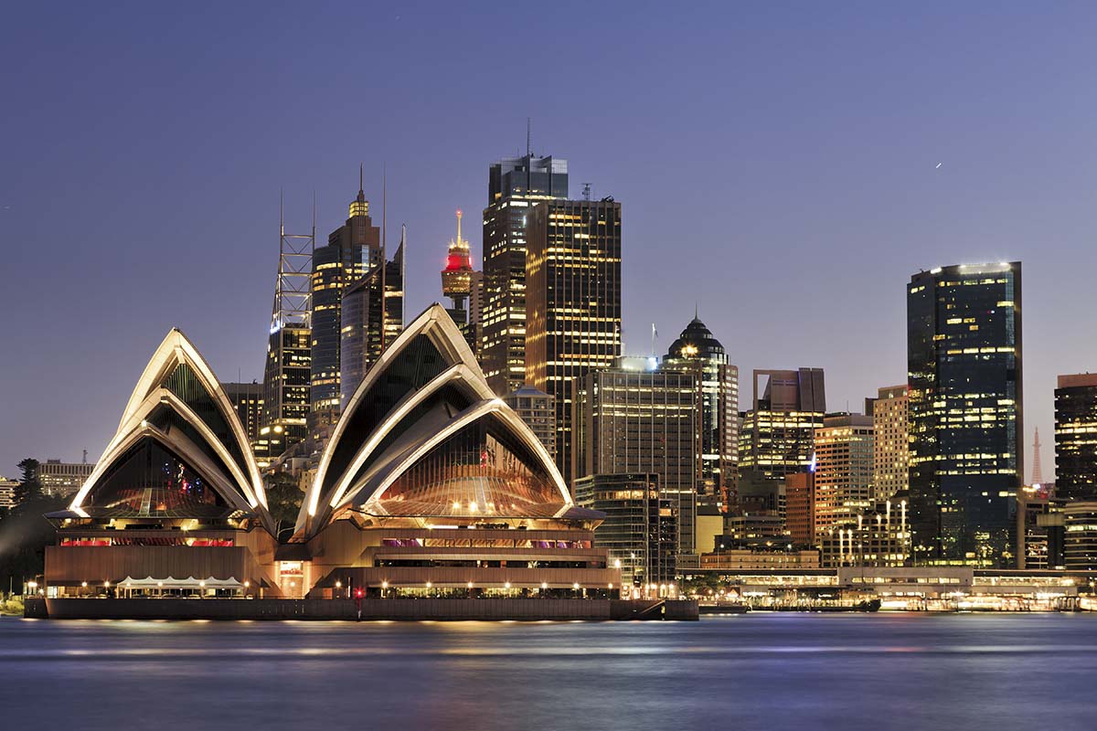 A city skyline with a building and water