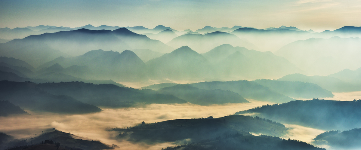 A foggy landscape of mountains