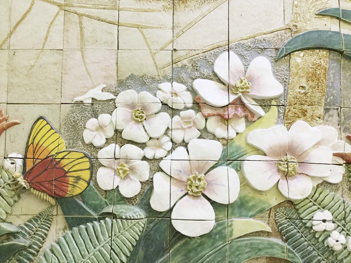 A tile wall with butterflies and flowers