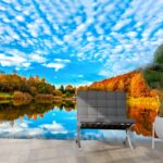 A lake with trees and clouds in the sky