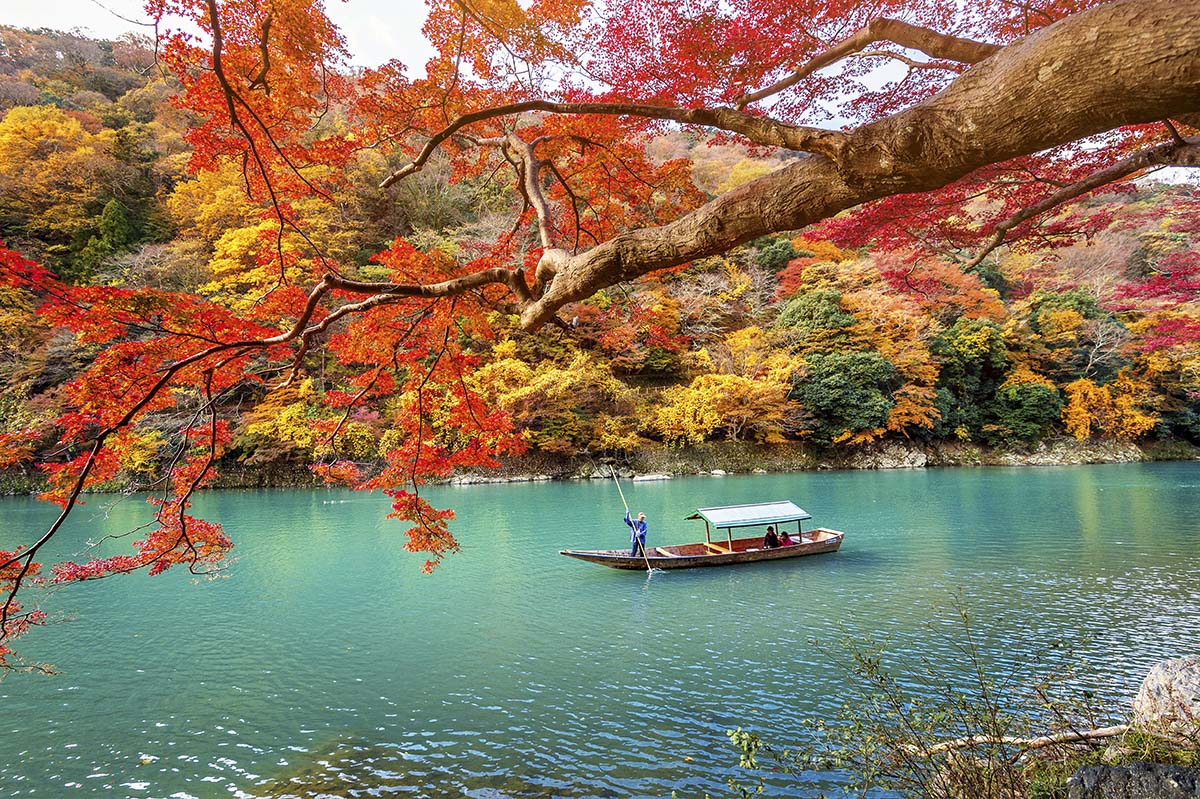 A boat on a lake with colorful trees