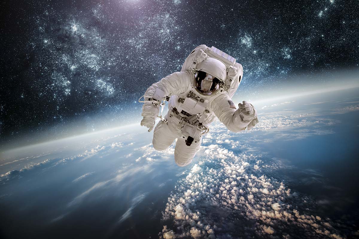An astronaut in space above earth