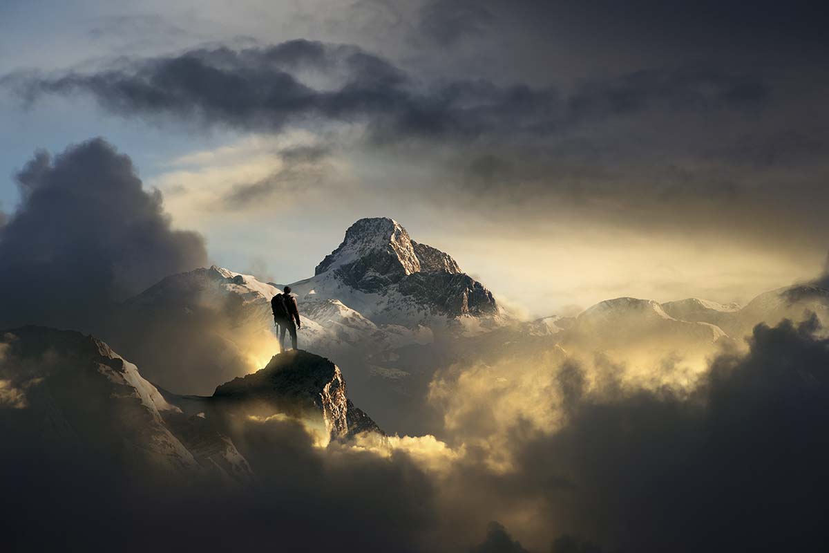 A person standing on a mountain peak