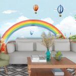 A cartoon landscape with a rainbow and houses