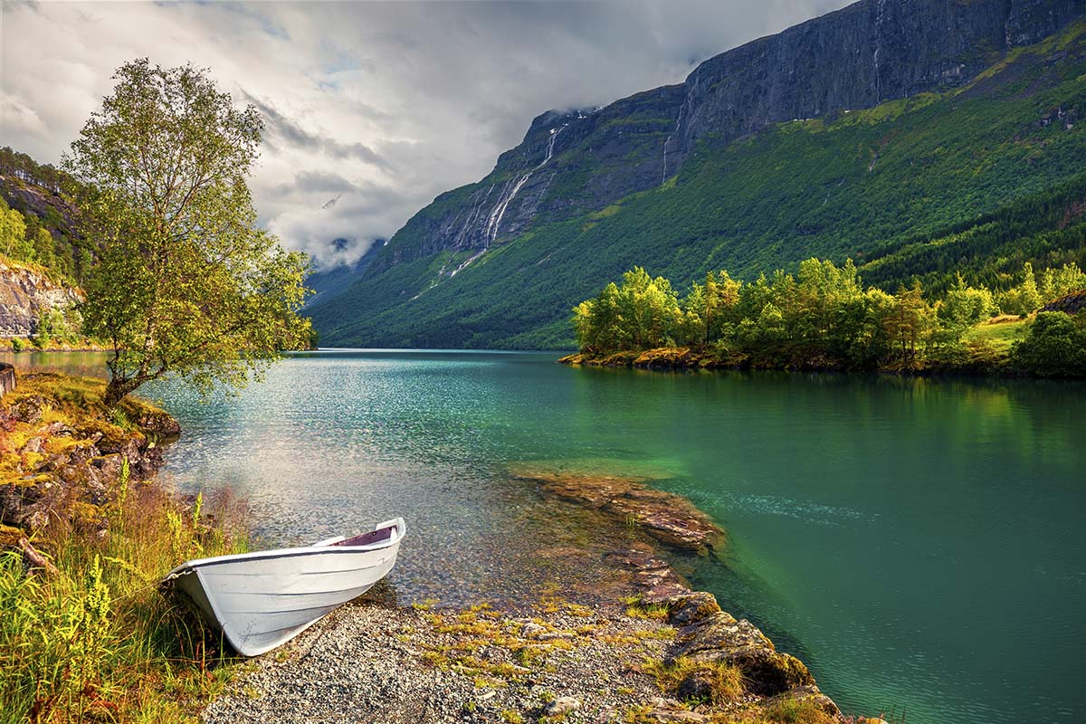 A boat on the shore of a lake