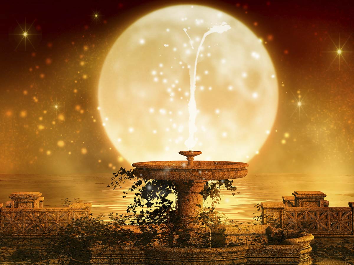 A water fountain with a full moon in the background