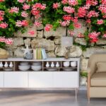 A stone wall with pink flowers