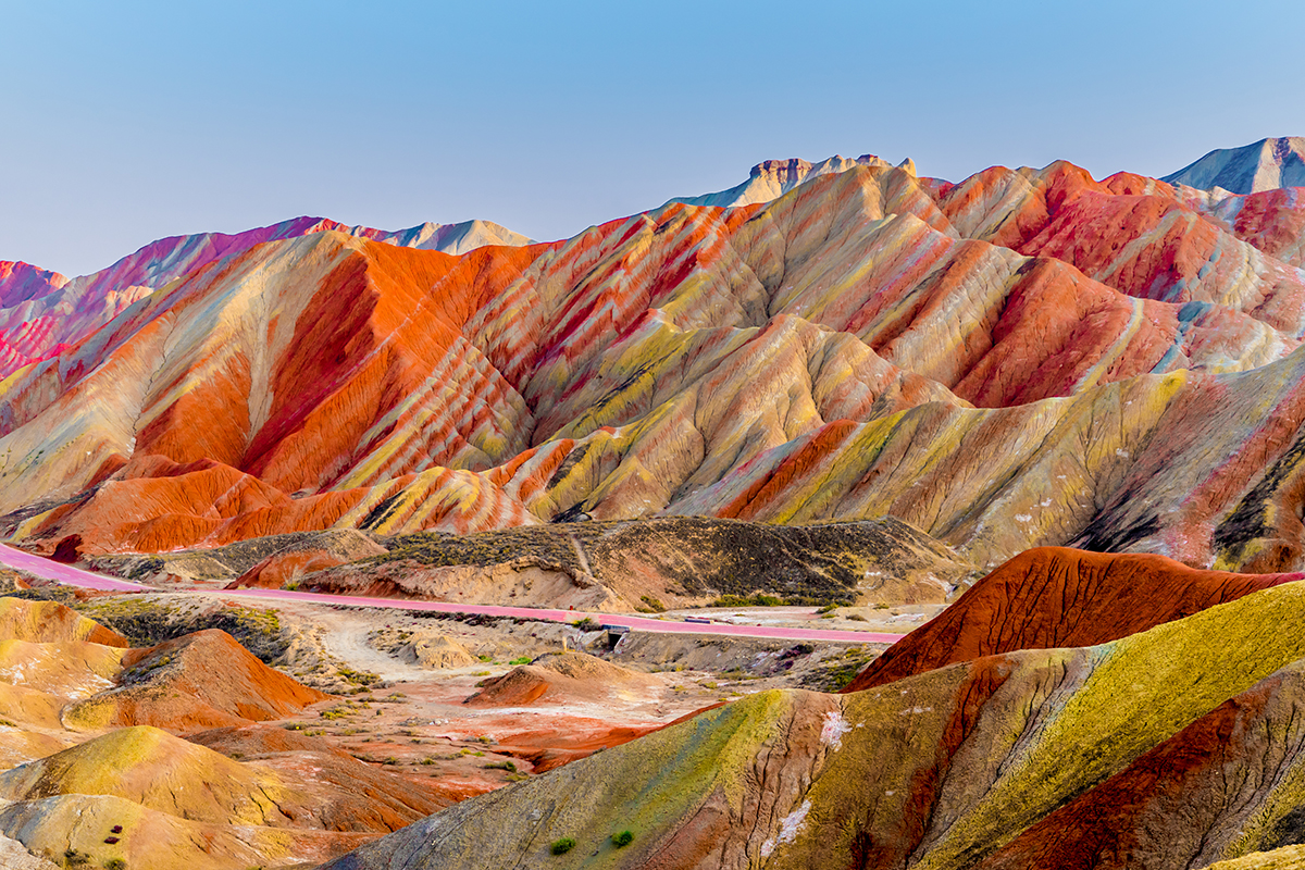 A colorful mountains with a road