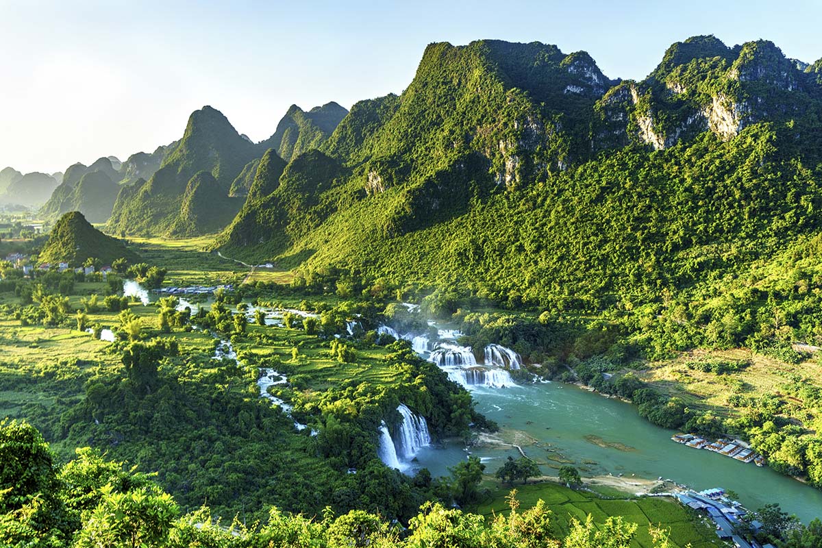 A waterfall surrounded by green hills