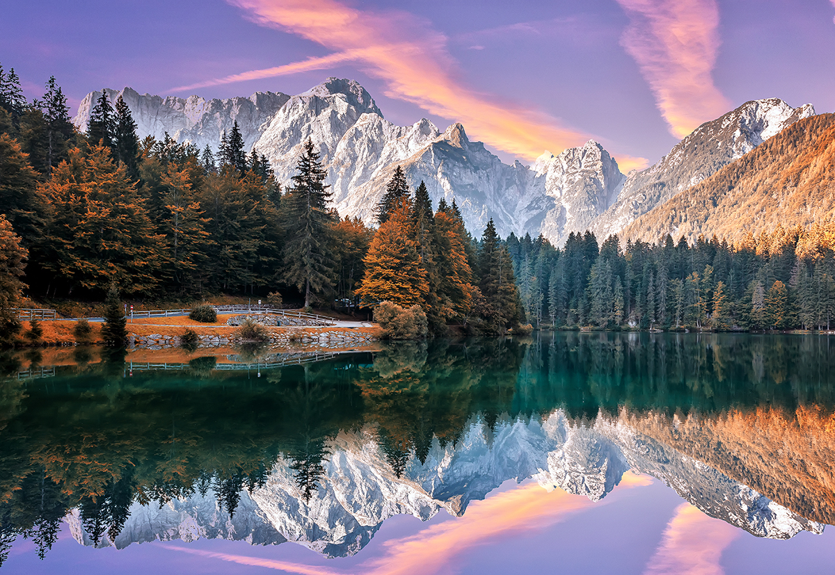 A lake with trees and mountains in the background
