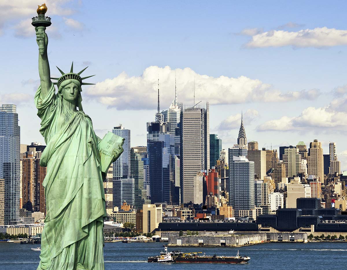 A statue of liberty with a city in the background